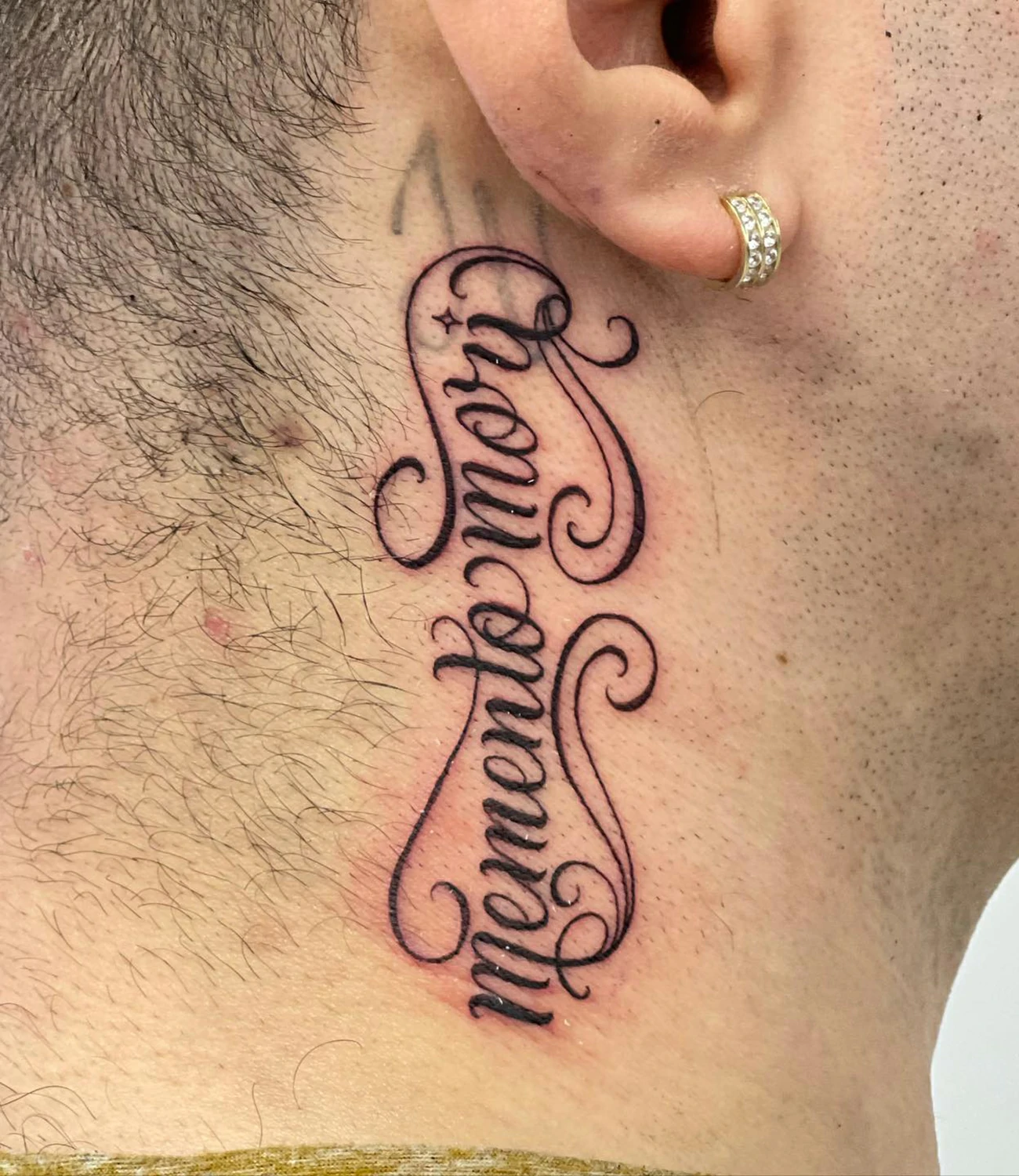 memento mori neck tattoo: A design suitable for the neck, incorporating "memento mori" in a way that complements the contours of the neck.