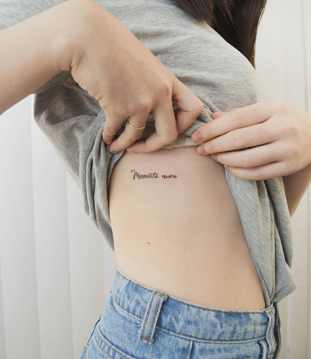 women's memento mori tattoo: A "memento mori" tattoo with a more delicate or feminine design, possibly including floral elements or softer lines.