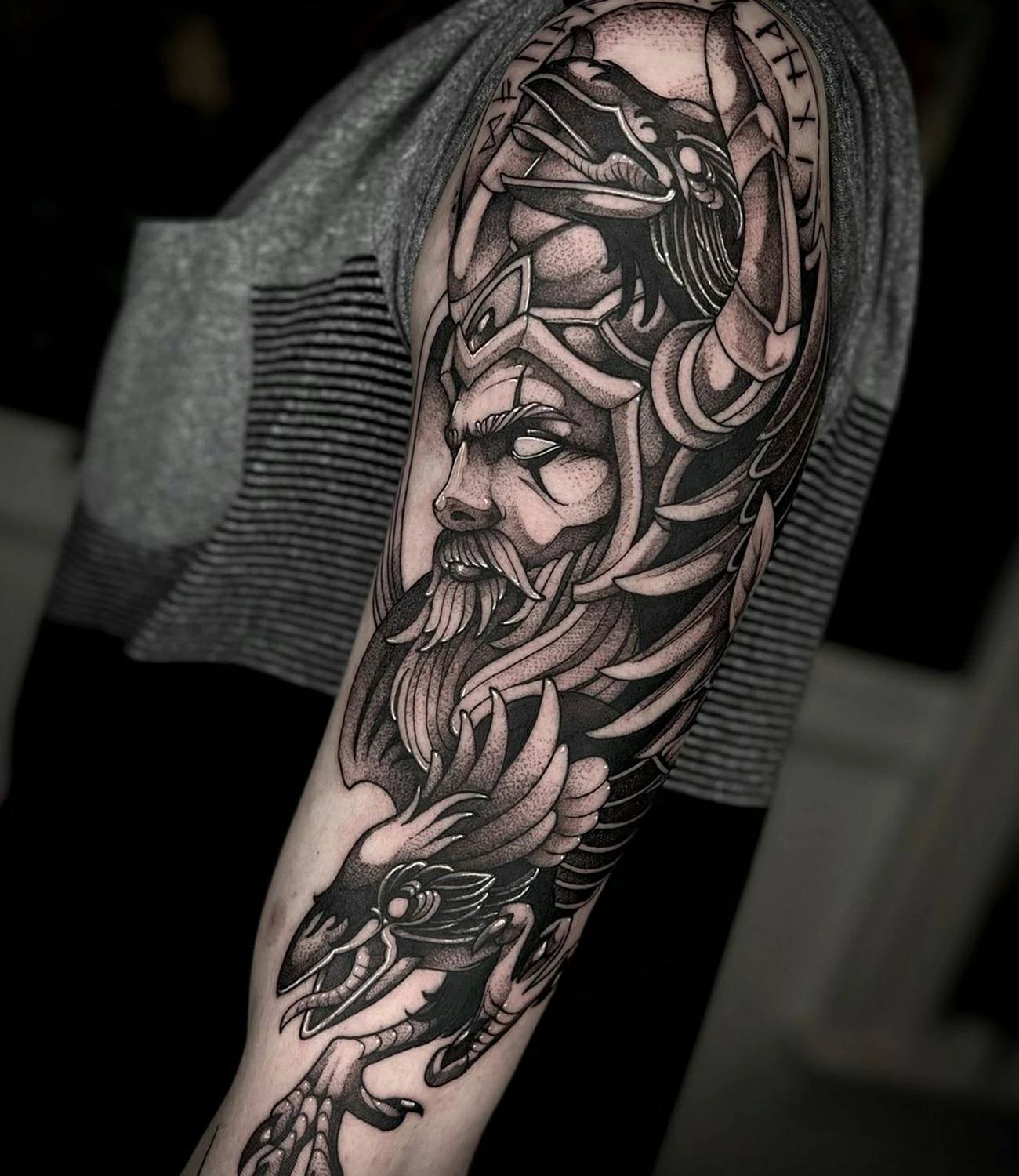 Odin's raven tattoo designs: Various tattoo designs featuring Odin’s ravens.