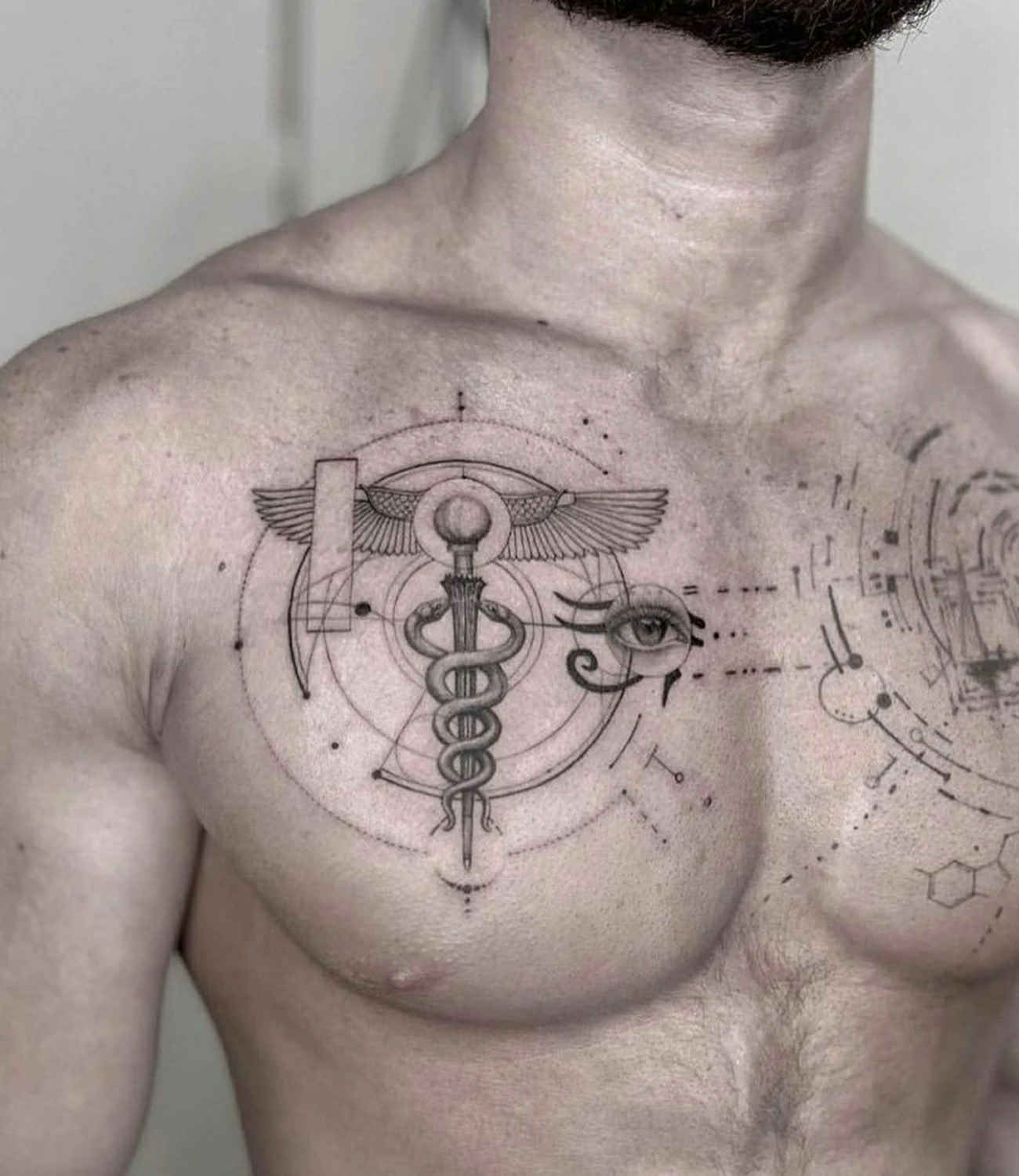 Geometric Chest Tattoo: Geometric chest tattoos are visually striking designs that cover the chest with symmetrical patterns and shapes.